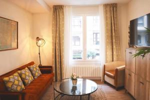 a living room with a couch and a table at Homeloving apartment Bilbao centre with Parking in Bilbao