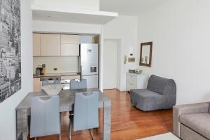 a kitchen and living room with a table and a chair at PRESTIGE BOUTIQUE HOMES -Duomo Galleria Vittorio Emanuele in Milan