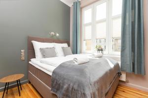 a bedroom with a large bed and a window at Sopot RIVOLI Apartments by Renters in Sopot