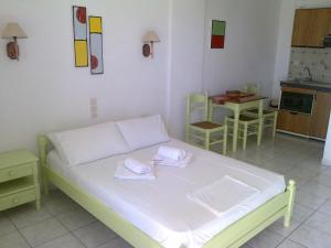 a bedroom with a bed with two towels on it at Aeolos Hotel Apartments in Gythio