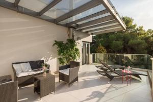 a patio with chairs and a table and awning at Villa Valsavia-apartment Monsena with pool and SPA in Rovinj