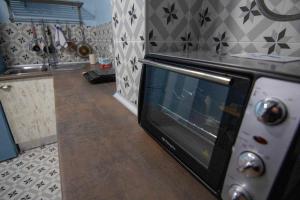 a kitchen with a microwave oven in a kitchen at HabitaHost Ramón y Cajal in Cuenca +22 photos