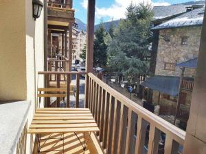 a wooden bench sitting on the balcony of a building at Estudio en El Tarter GRANDVALIRA in El Tarter