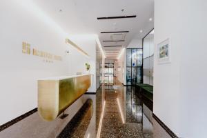 a lobby of a building with a gold and white at Habitat Hotel Tirana in Tirana