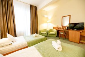Postel nebo postele na pokoji v ubytování Hotel Rivulus