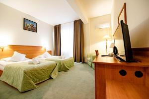 Postel nebo postele na pokoji v ubytování Hotel Rivulus