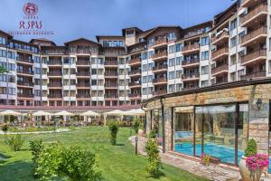 a large hotel with a swimming pool in a yard at Апартамент Лукс в Спа Хотел Свети Спас in Velingrad