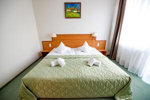 Postel nebo postele na pokoji v ubytování Hotel Rivulus