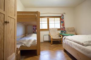 a bedroom with two bunk beds and a desk at Penzion Krizky in Malá Skála