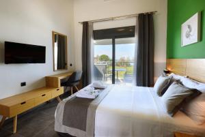 A bed or beds in a room at Botanica Luxury Suites