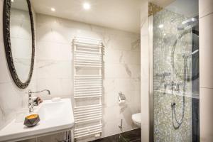 a bathroom with a sink and a shower at Hotel Imperial - Liburnia in Opatija