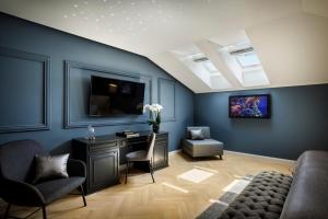 a living room with a couch and a desk at Hotel Imperial - Liburnia in Opatija