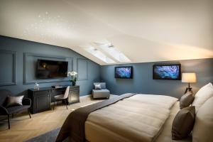 a bedroom with a large bed and a desk and a desk at Hotel Imperial - Liburnia in Opatija