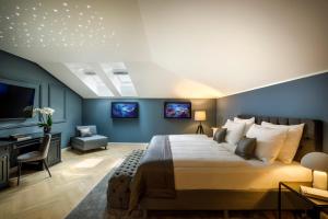 a bedroom with a king sized bed and a desk at Hotel Imperial - Liburnia in Opatija