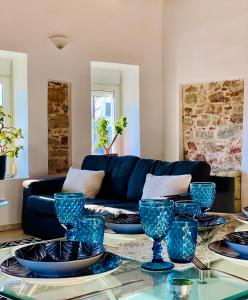 a living room with blue dishes on a glass table at Iras in Samos