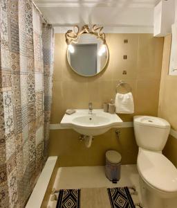a bathroom with a toilet and a sink and a mirror at Iras in Samos