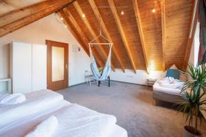 a bedroom with two beds and a hammock in it at FeWo Immenstaad 2 in Immenstaad am Bodensee