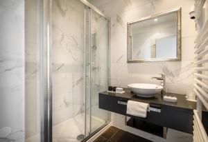 a bathroom with a sink and a glass shower at Hotel Imperial - Liburnia in Opatija
