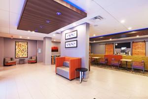 a waiting area of a hospital with chairs and tables at Holiday Inn Express & Suites Perryton, an IHG Hotel in Lord