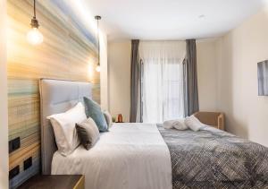 Posteľ alebo postele v izbe v ubytovaní Home Art Apartments Soho + 37 fotografií