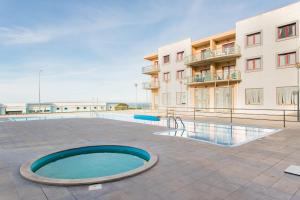 a swimming pool in front of a building at Beach House Ericeira in Ericeira