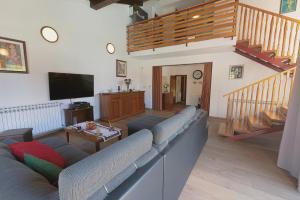a living room with a couch and a flat screen tv at Kuntrada 45 Holiday Home - Heated & Kids Pool in Fažana