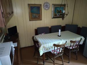 a dining room table with chairs and a clock on the wall at casa di Enzo:relax a 2 passi dal mare in Camaiore