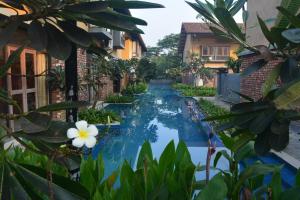 a view of a swimming pool between two buildings at Ganga kutir Residency Villa in Raichak