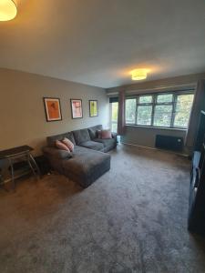 a living room with a couch and a table at Central 2 bed apartment in Wolverhampton