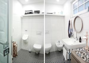 uma casa de banho branca com um WC e um lavatório em Malvasia Apart em Stumm