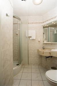 a bathroom with a shower and a sink and a toilet at Hôtel de l'Univers Liège in Liège +68 photos