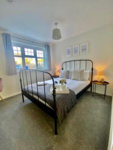 a bedroom with a large bed with a metal frame at Chase Heights in Rugeley