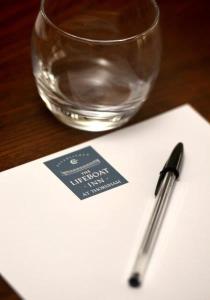 a pen sitting on top of a napkin next to a glass at The Lifeboat Inn in Hunstanton