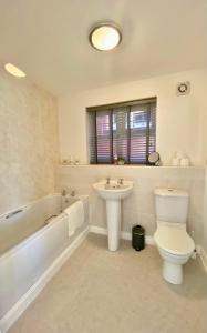 a bathroom with a sink and a toilet and a bath tub at Chase Heights in Rugeley
