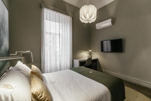 Uma cama ou camas num quarto em Royal Collection Covilh