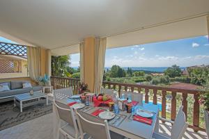 a dining room with a table and chairs on a balcony at Dulcamara con piscina by Wonderful Italy in Soiano del Lago