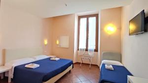 Postel nebo postele na pokoji v ubytování Hotel Rita Major