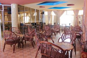 a dining room with tables and chairs and a blue ceiling at Pearl Palace Hotel in Nairobi
