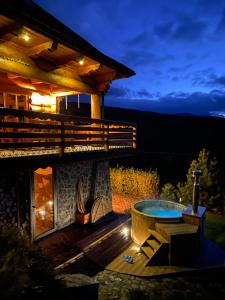 a backyard with a pool and a house at night at Rezydencja Zawoja in Zawoja