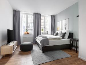 a bedroom with a large bed and a television at Limehome Bremen Hutfilterstraße in Bremen +42 photos