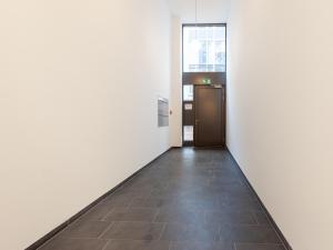 a hallway of an office building with a door at Limehome Bremen Hutfilterstraße in Bremen