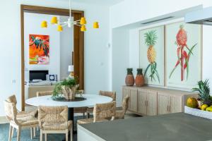 a kitchen with a table and chairs and paintings on the wall at Finca Cortesin Hotel Golf & Spa in Casares