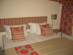
a hotel room with a bed and two nightstands at Hospedaria Frangaria in Faro
