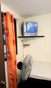 A television and/or entertainment centre at Hostel Dodero