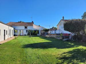 a large yard with a house and a playground at Gîte Mélisse in Mouilleron-le-Captif