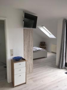 a bedroom with a bed and a tv on the wall at Ferienwohnung Bellevue in Saarbrücken