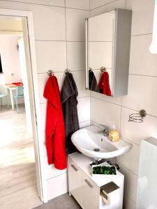 a bathroom with a sink and a mirror at Ferienwohnung Bellevue in Saarbrücken