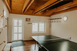 a kitchen with a ping pong table in a room at Dovolenkové domy Pilarčík in Zuberec