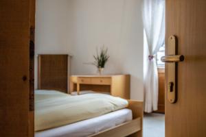 アラッバにあるAffittacamere Blankのベッドルーム1室(ベッド1台、テーブル、窓付)