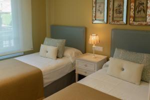 Cama o camas de una habitación en Apartamento Bajo en Isla de la Toja